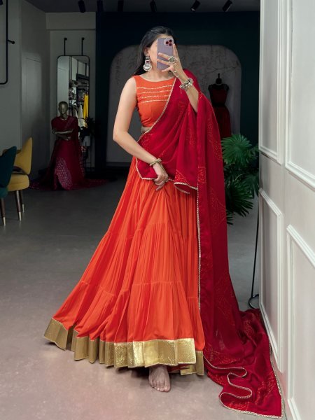 Mesmerizing Orange Rayon Lehenga Choli with Embossed Lace Work and Dupatta For Navratri Navratri Lehnega Choli