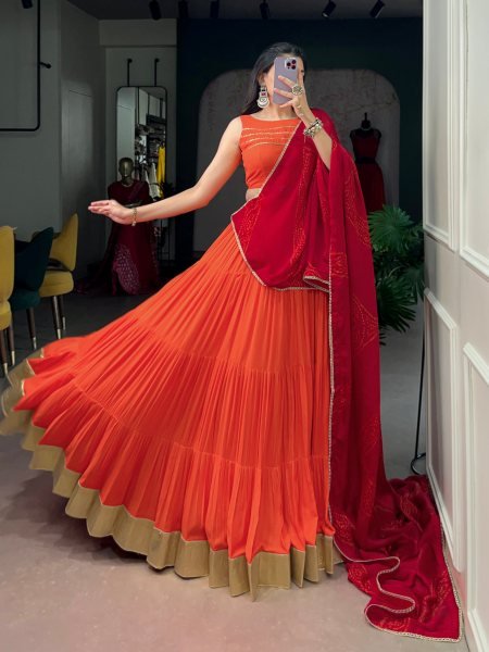 Mesmerizing Orange Rayon Lehenga Choli with Embossed Lace Work and Dupatta For Navratri Navratri Lehnega Choli