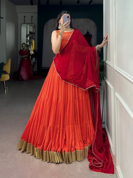 Mesmerizing Orange Rayon Lehenga Choli with Embossed Lace Work and Dupatta For Navratri Navratri Lehnega Choli