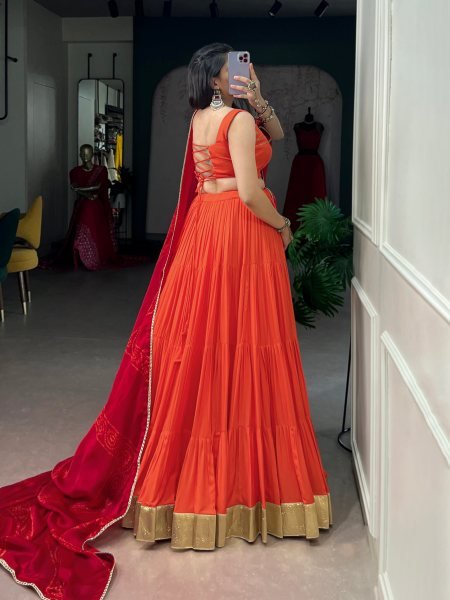 Mesmerizing Orange Rayon Lehenga Choli with Embossed Lace Work and Dupatta For Navratri Navratri Lehnega Choli